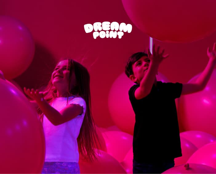 Young children playing among soft balloons at Dream Point